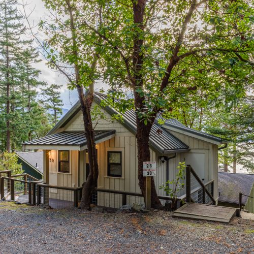 Tucked beneath towering evergreens, this ultra-luxury hideaway welcomes you the moment you arrive. A serene, tree-lined entry sets the tone for slow mornings, ocean-view hikes, wine on the deck, and evenings by the fire. Privacy, peace, & pure island