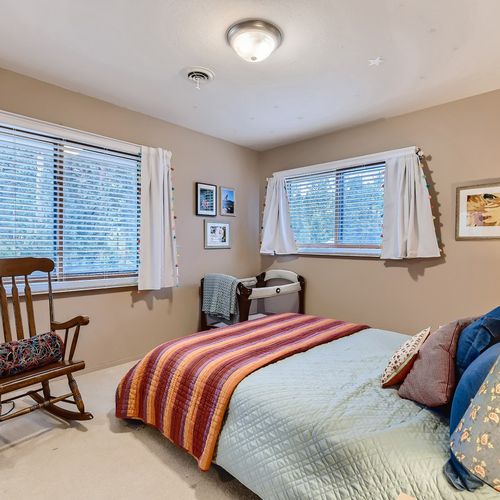 In this bedroom you will find a comfy queen-sized bed, a pack n play for young ones. The rocking chair in the room adds a nice touch of coziness.