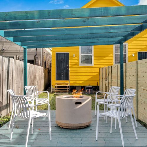 Covered outdoor lounge w/ string lights — your go-to spot day or night.
