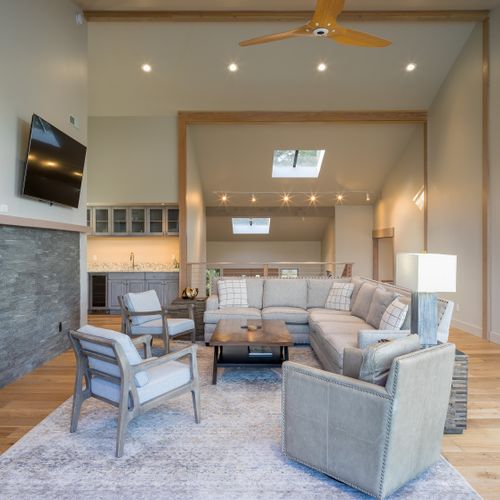 Spacious living with a game table, wet bar, fireplace, and a Smart TV.