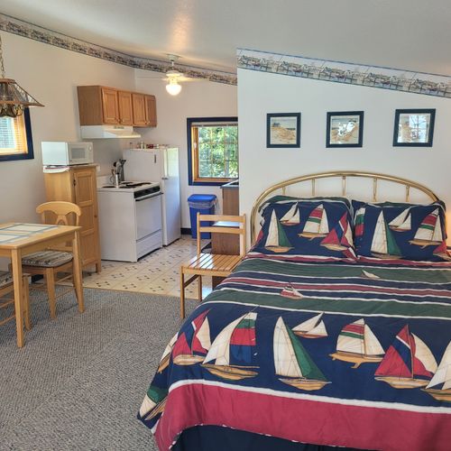 Main room:  the queen-size bed and dining table with the kitchen in the background