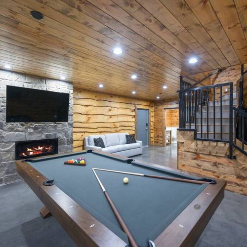 The game room with a pool table and fireplace!