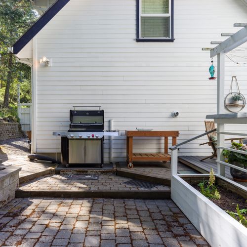 Large five burner Weber Genesis BBQ with all the accessories for gourmet grilling.