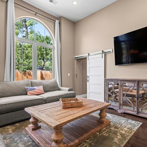 Bright lounge with curated décor and calming green views.