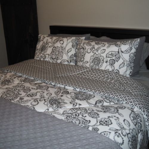 Bedroom #2 (main floor):  features a queen-size bed, ceiling fan, dresser, and closet.