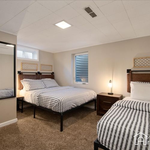 The spacious basement bedroom has a queen and a single bed.