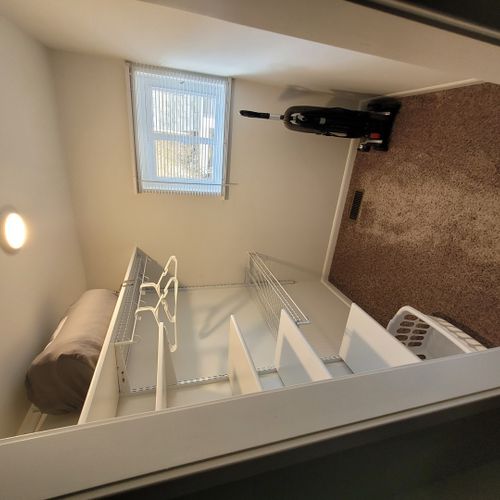 Bedroom #1:  features a queen-size bed, private en suite full bathroom, private television, walk-in closet, dresser, mirror, nightstands, and lamps