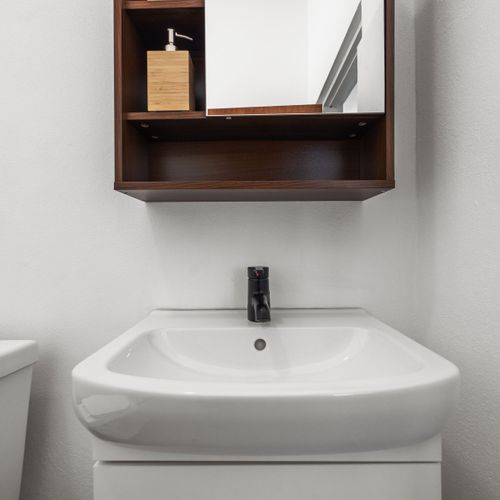Indulge in comfort and style in this spotless bathroom, offering all the essentials for a relaxing retreat.