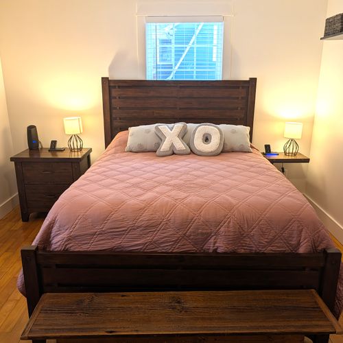 BEDROOM #1 (MAIN FLOOR):  Gorgeous main floor bedroom with a queen-size bed, nightstands, lamps, ceiling fan, dresser, mirror, and closet.