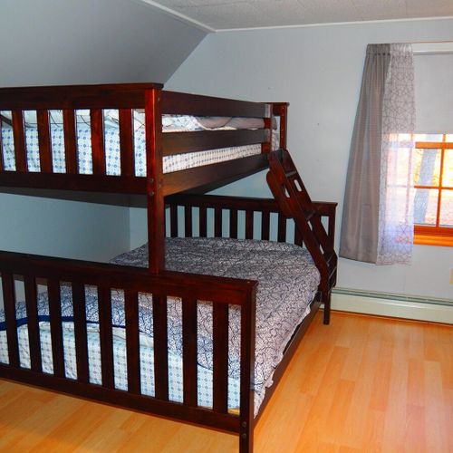 Bedroom #3 (second floor):  includes a queen-size bed, a full-size bed, and a twin-on-full bunk bed. Also has a dresser. Closet, and ceiling fan.