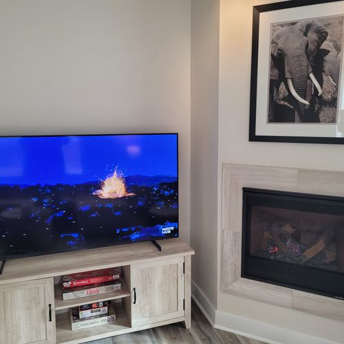 LIVING ROOM:  Gorgeous living room that features a gas fireplace and a large television with live streaming via Hulu, Netflix, and Disney+.