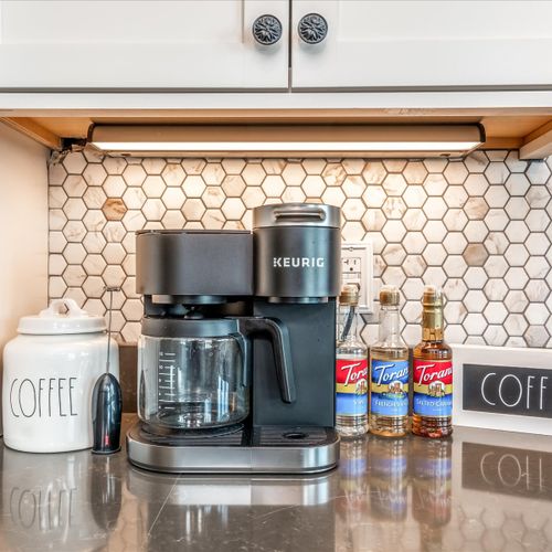 Fully-stocked torani coffee bar with special edition keurig coffee maker for a morning brew.