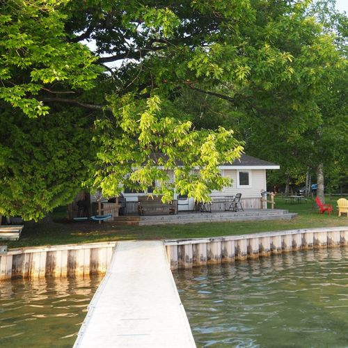 Exterior:  another view of the cottage, deck, lake, and private dock.