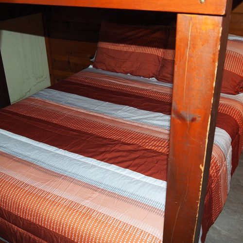 Bedroom #2:  features a full-on-full bunk bed, dresser, closet, and chair.