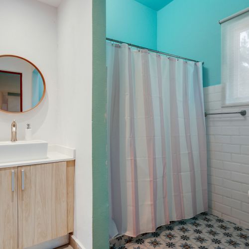 A clean bathroom with a big mirror, perfect for getting ready.