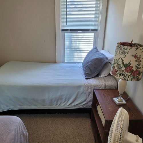 BEDROOM #3 (SECOND FLOOR):  Features 2 twin beds, a nightstand, lamp, and a closet.