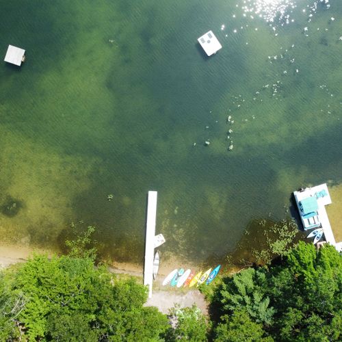 Exterior:  an aerial view of the private lakefront. Note that private swim raft at the top of the photo.