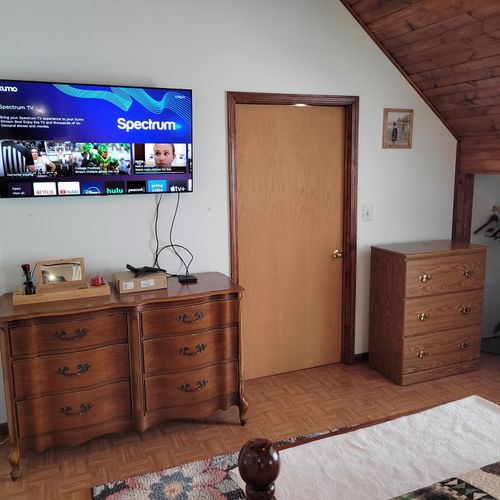 Bedroom #2 (second floor):  very large bedroom features a queen-size bed, walk-out deck, chair, 2 nightstands, 2 lamps, 2 dressers, ceiling fan, television, and private en suite full bathroom