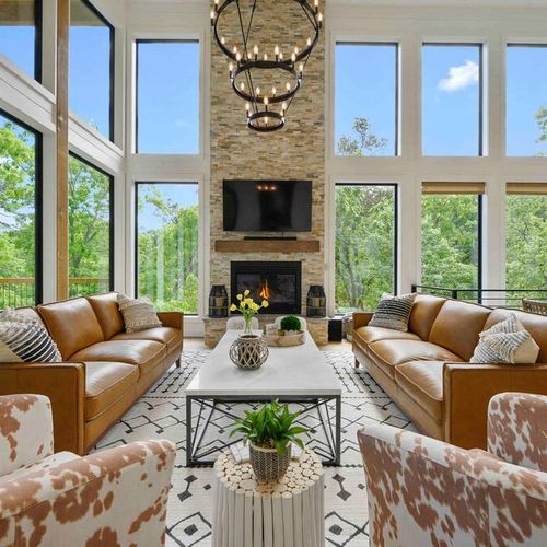 The living area with matching couches and chairs around a stone fireplace!