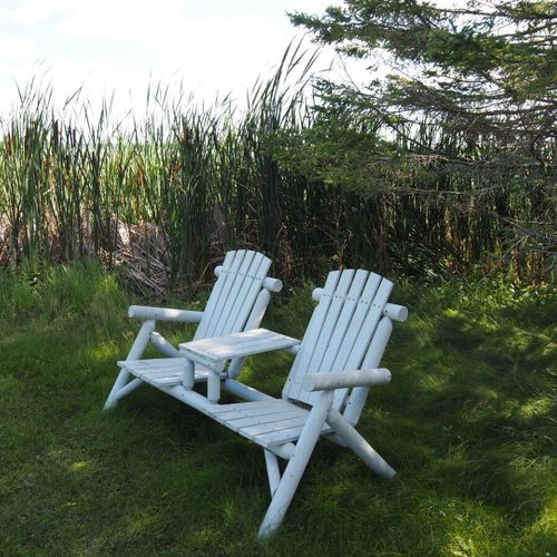 Exterior:  adirondack chairs in the backyard on the lake