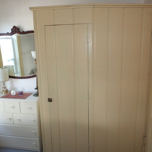 Bedroom #2 (main floor):  features a full-size bed, mirror, dresser, and closet.