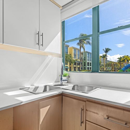 A clean, spacious kitchen featuring modern amenities and a breathtaking outdoor view.