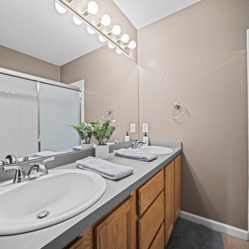Spacious bathroom with double vanities for shared convenience