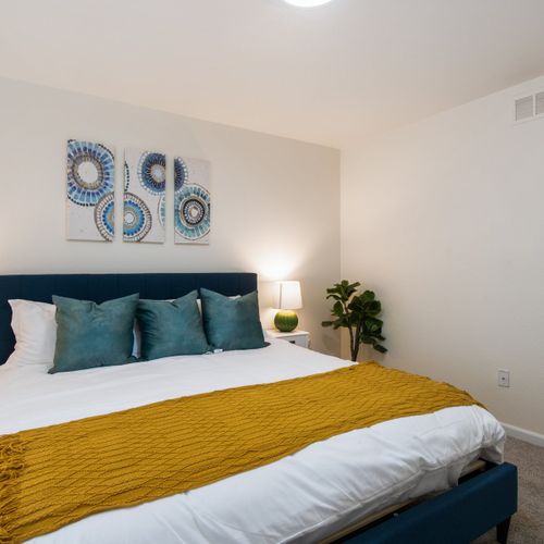 The master bedroom features a king size bed with plush linens, night stands, plenty of space for your luggage, and an attached bathroom. The ensuite bathroom consists of a tub/shower combo, toilet, and tub. Toiletries are provided for your convenienc