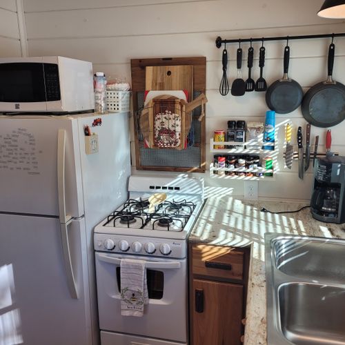 Kitchen:  the cabin has a cute little kitchen with all appliances except for a dishwasher. Includes a good supply of cooking and dining utensils as well.
