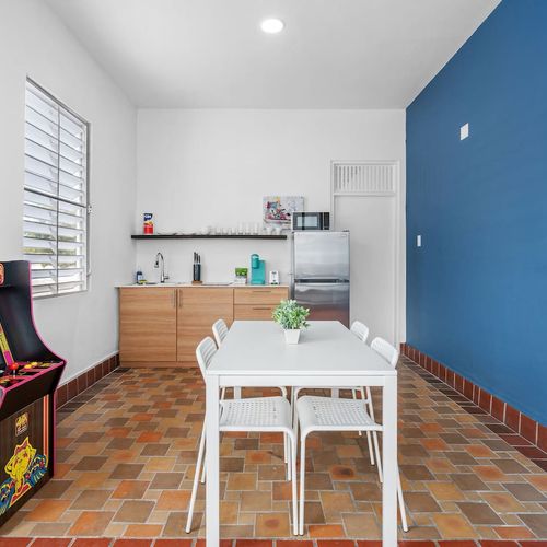 Step into a room designed for relaxation or productivity, enhanced by the presence of an arcade machine.