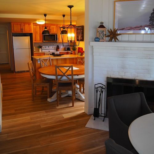 Living room:  the home has a very comfy living room with all new furniture, a ceiling fan, great views of crystal lake, a game table, and a wood-burning fireplace!