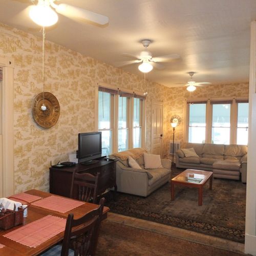 Living room:  the cottage has a comfy living room with a sofa, comfy chairs, television with live streaming, and great views of crystal lake!