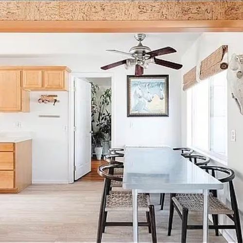 Gather, relax, and share meals in this wood-toned space with natural light and charm.