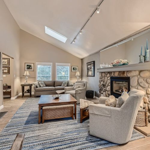 With tall, vaulted ceiling, a stone-built gas lit fireplace, and plenty of seating, this area has everything needed to make you feel at home.