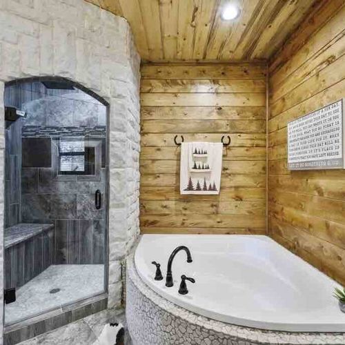 In-suite bathroom with a soaking tub and a stone walk-in shower.