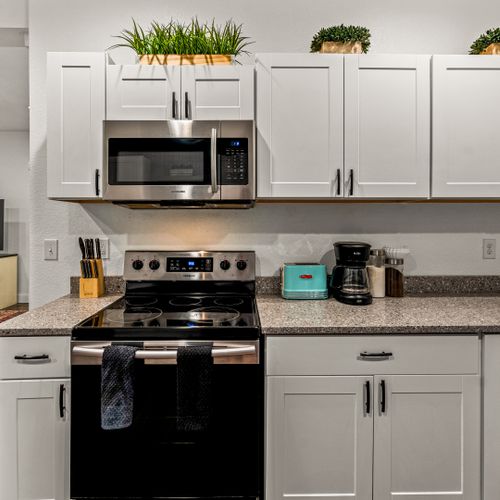 This kitchen features abundant cabinetry and ample space, making cooking and organizing effortless.
