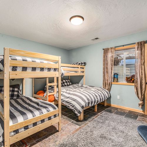 - fun and functional bunk room with two twin over full beds and cozy striped linens