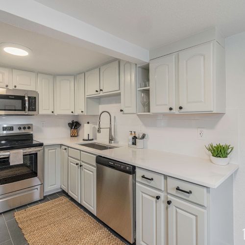 Prepare culinary delights with ease in this fully equipped space with new cabinetry, stone countertops, ceramic tile floors, and stainless steel appliances.