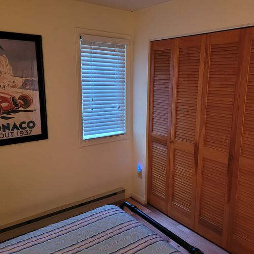 BEDROOM #3 (FIRST FLOOR):  Features two twin beds, a nightstand, lamp, dresser, and closet