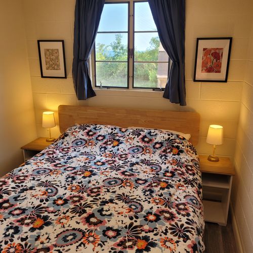 Bedroom #1:  features a queen-size bed, nightstands, lamps, mirror, and closet.