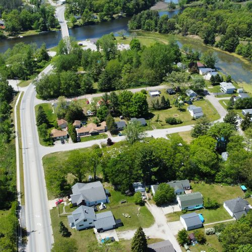 Exterior:  looking west with the house in the foreground and the au sable river in the background.