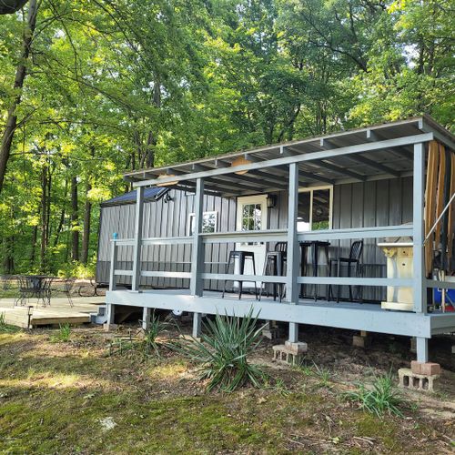 Overview:  the front of the tiny house, highlighting the large deck with lakeview!