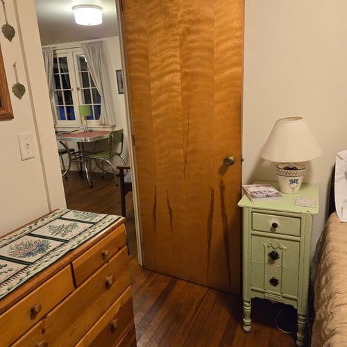 Bedroom #2:  features a full-size bed, nightstand, lamp, and dresser.