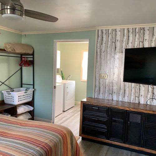 Bedroom:  cute bedroom with queen-size bed, ceiling fan, private streaming television, dresser, closet, nightstand, and lamp.