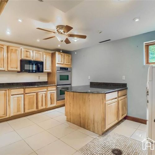 Downstairs you will find the laundry room, a bathroom, and a family/living room area.
