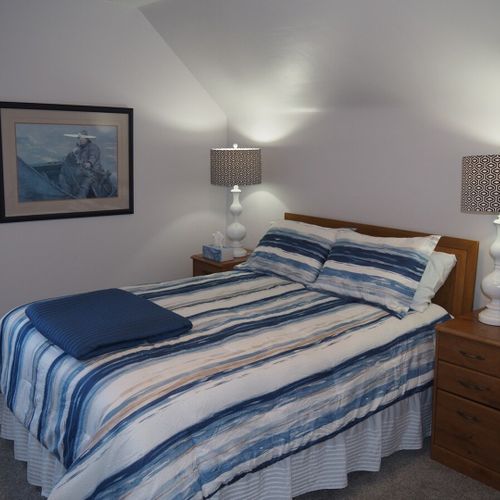 Bedroom #1:  all 3 bedrooms are upstairs. This bedroom features a queen-size bed, nightstands with lamps, dresser, chair, and a large closet.