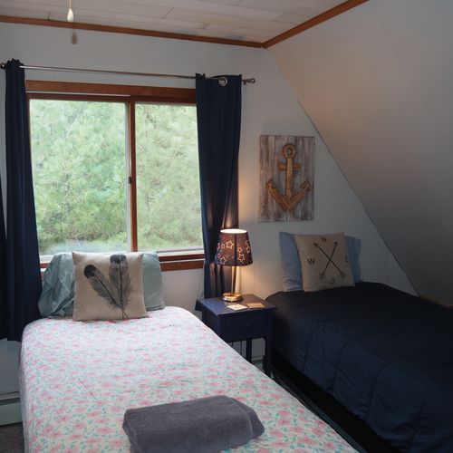 Bedroom #4 (second floor):  features 3 twin-size beds, nightstands with lamps, ceiling fan, closet, dresser, chair, and its own private television.