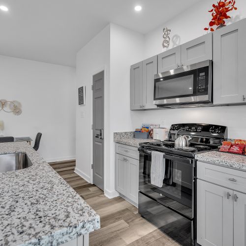 Enjoy the convenience of a modern kitchen with sleek granite countertops, a full suite of appliances, and all the essentials you need for a home-cooked meal. Perfect for both quick snacks and gourmet creations!