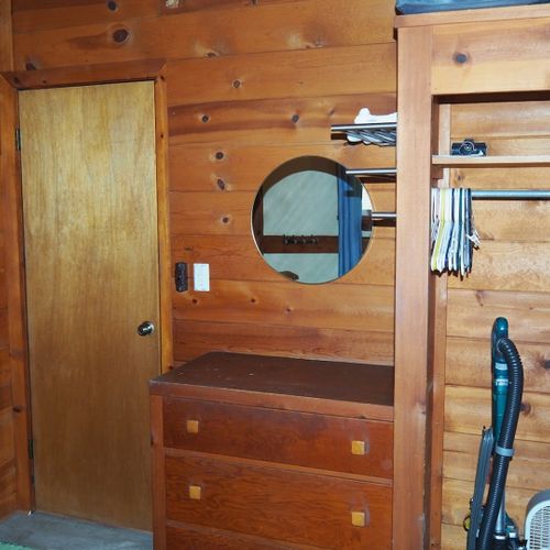 Bedroom #1:  features a full-size bed, chair, dresser, closet, and mirror.