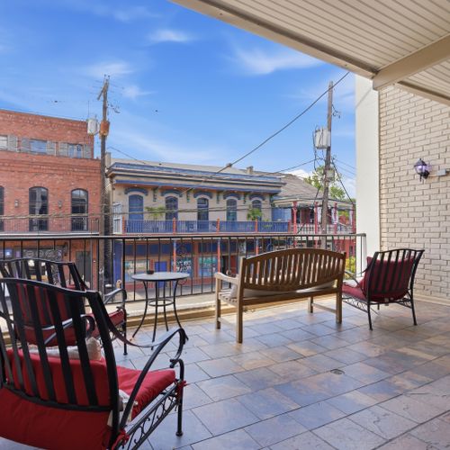 Balcony seating w/ open-air views of the surrounding neighborhood